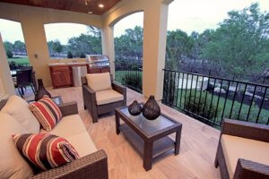 Outdoor porch with three piece striped furniture set